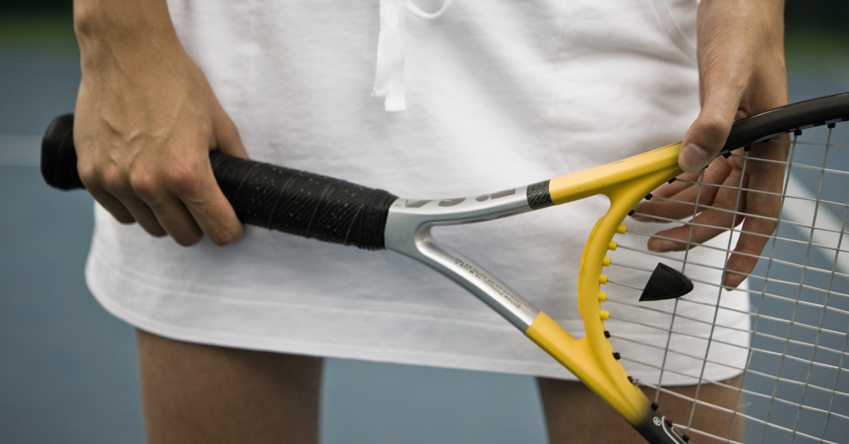 A closeup of a tennis player holding a racquete