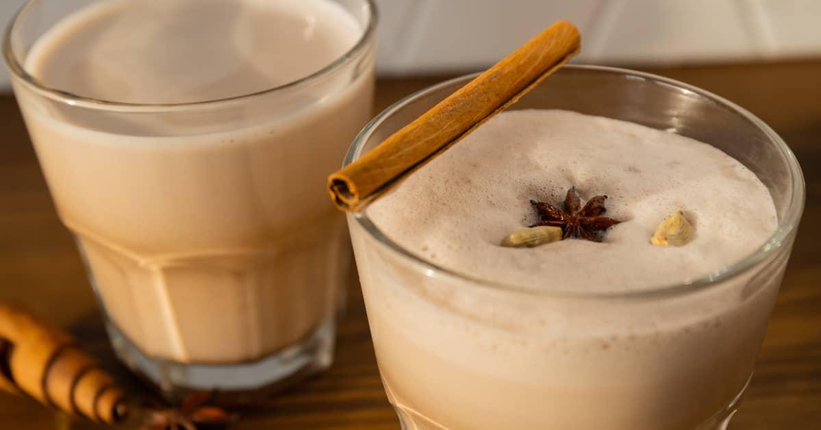 Extreme close up of two chai lattes with some ingredients artfully decorating the drinks