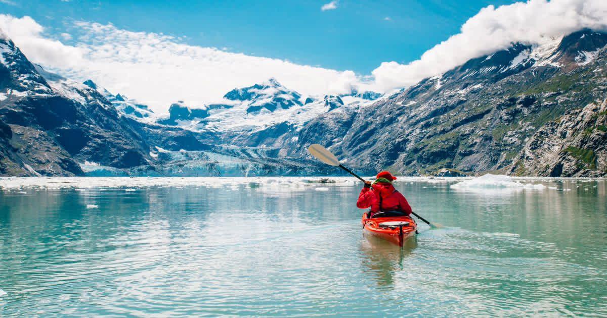 A woman kayaking in Glacier Bay National Park. (Representative Cover Image Source: Getty Images | Cavan Images/Brent Doscher)