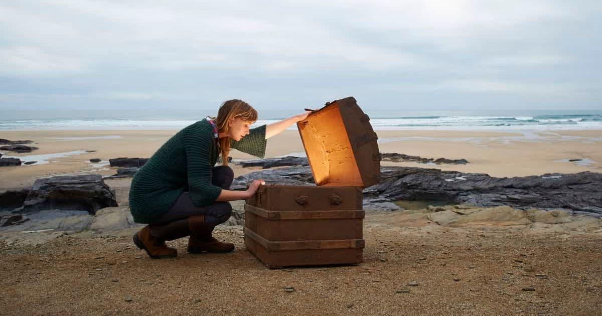 A woman looks inside a treasure chest (Representative Cover Image Source: Getty Images | Dougal Waters)