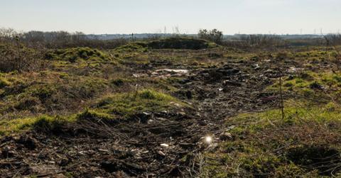 Debris is scattered all across the Arnolds Field landfill. (Cover Image Source: Getty Images | Photo By Dan Kitwood)