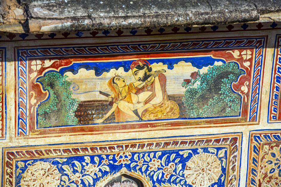 A close-up of ceiling art of two deities, one female and one male, practicing tantra. 