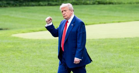 Donald Trump walks through the White House Rose Garden