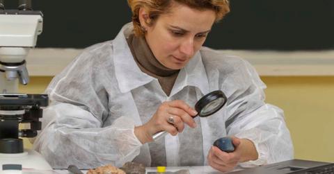 A scientist is studying a rock in the lab. (Representative Cover Image Source: Getty Images | Razvan)