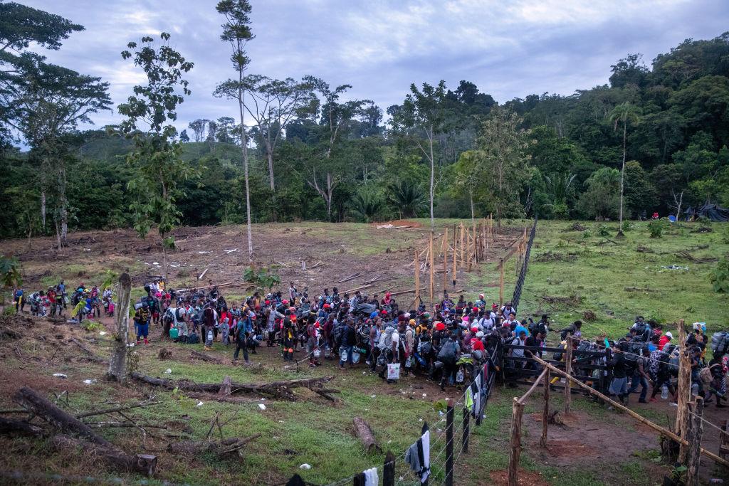 A large group of mostly Haitian migrants leaving their base camp during their journey through the Darien Gap.