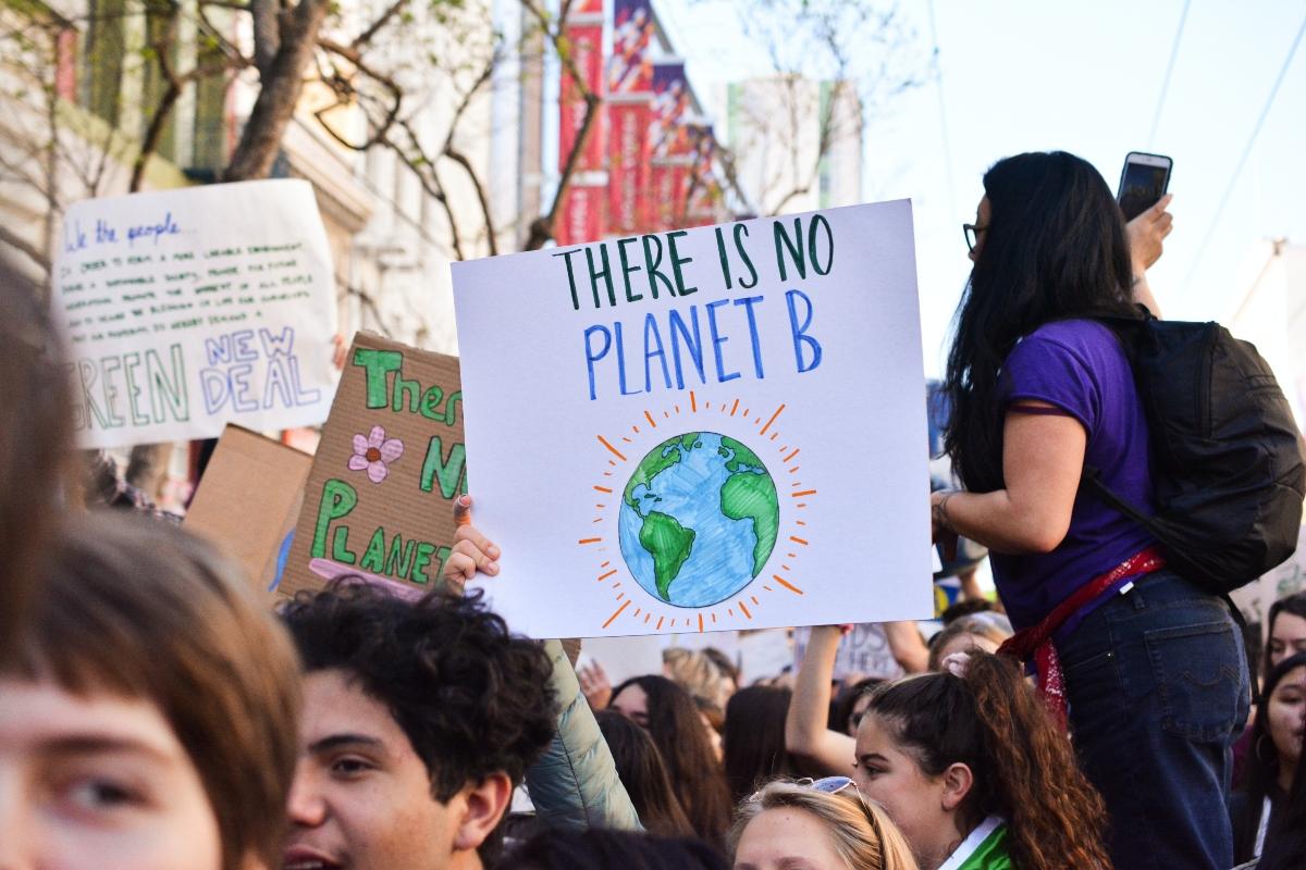 people at climate protest with poster saying "There Is No Planet B"