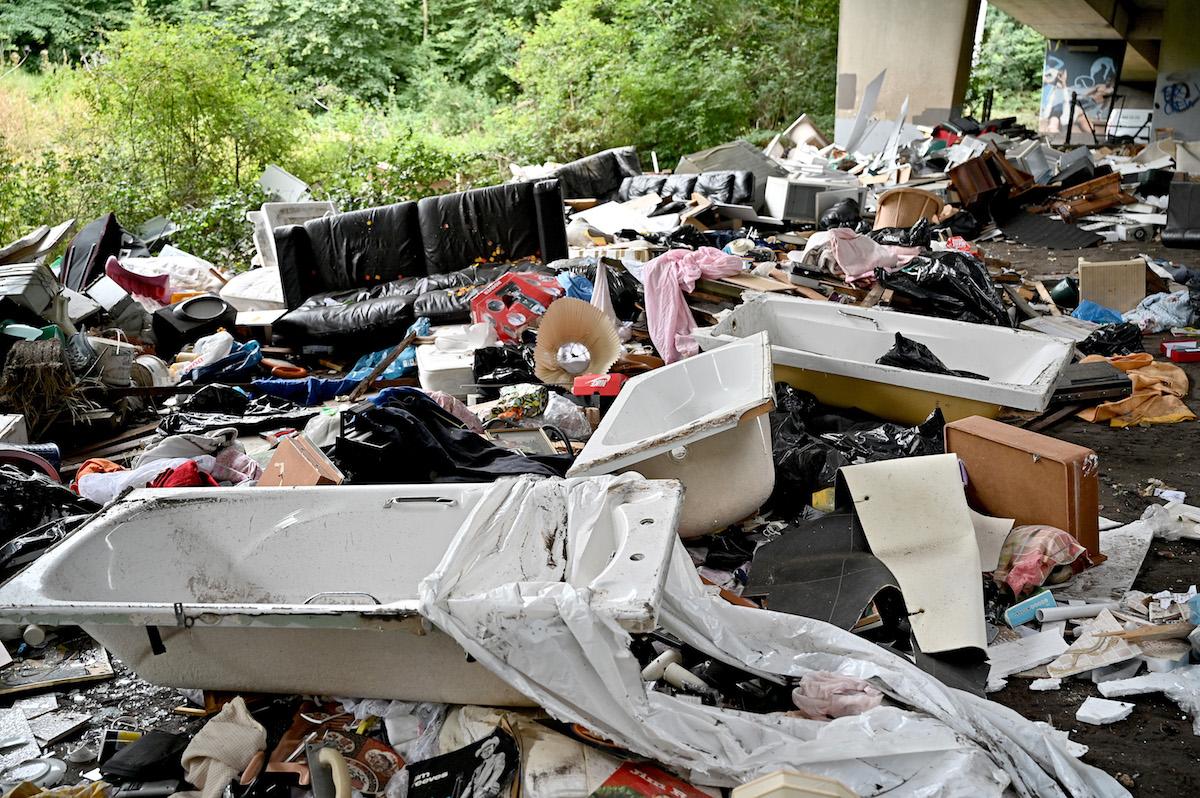 Trash dumped under an overpass