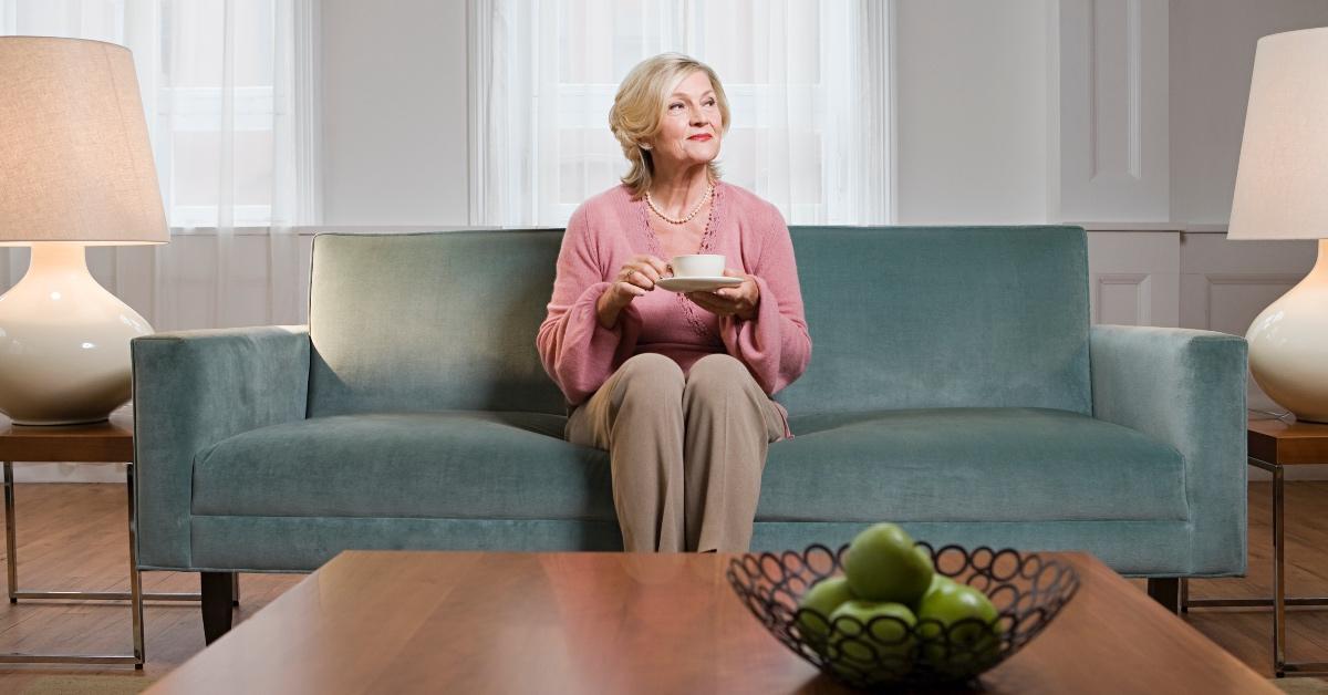 Lady sitting on her couch.