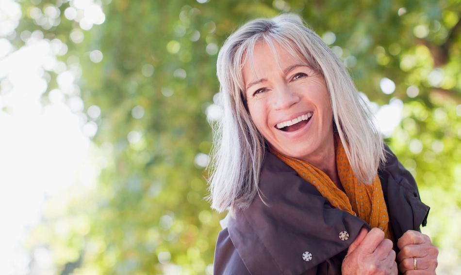 A woman with grey hair smiling. 