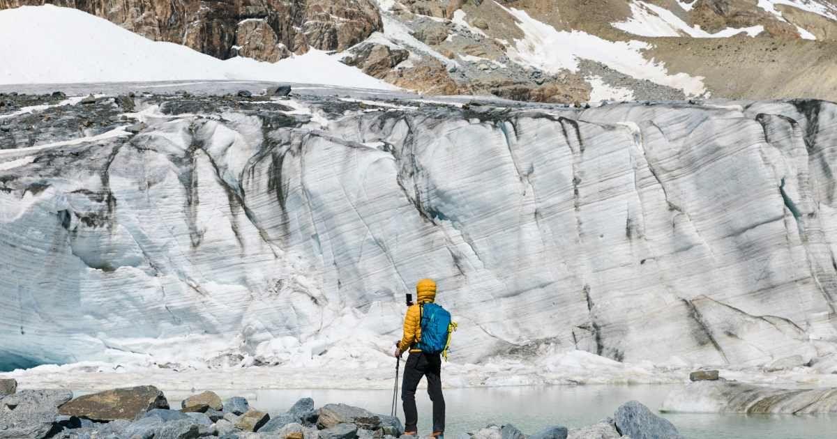 A hiker is watching the melting glacier in the Alps. (Representative Cover Image Source: Getty Images | Westend61)