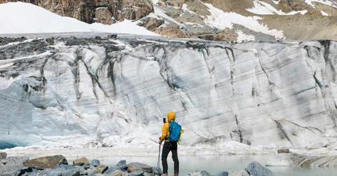 A hiker is watching the melting glacier in the Alps. (Representative Cover Image Source: Getty Images | Westend61)