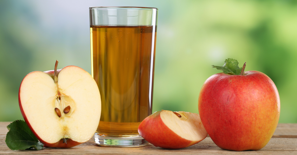 Apples and a glass of apple juice on a table 