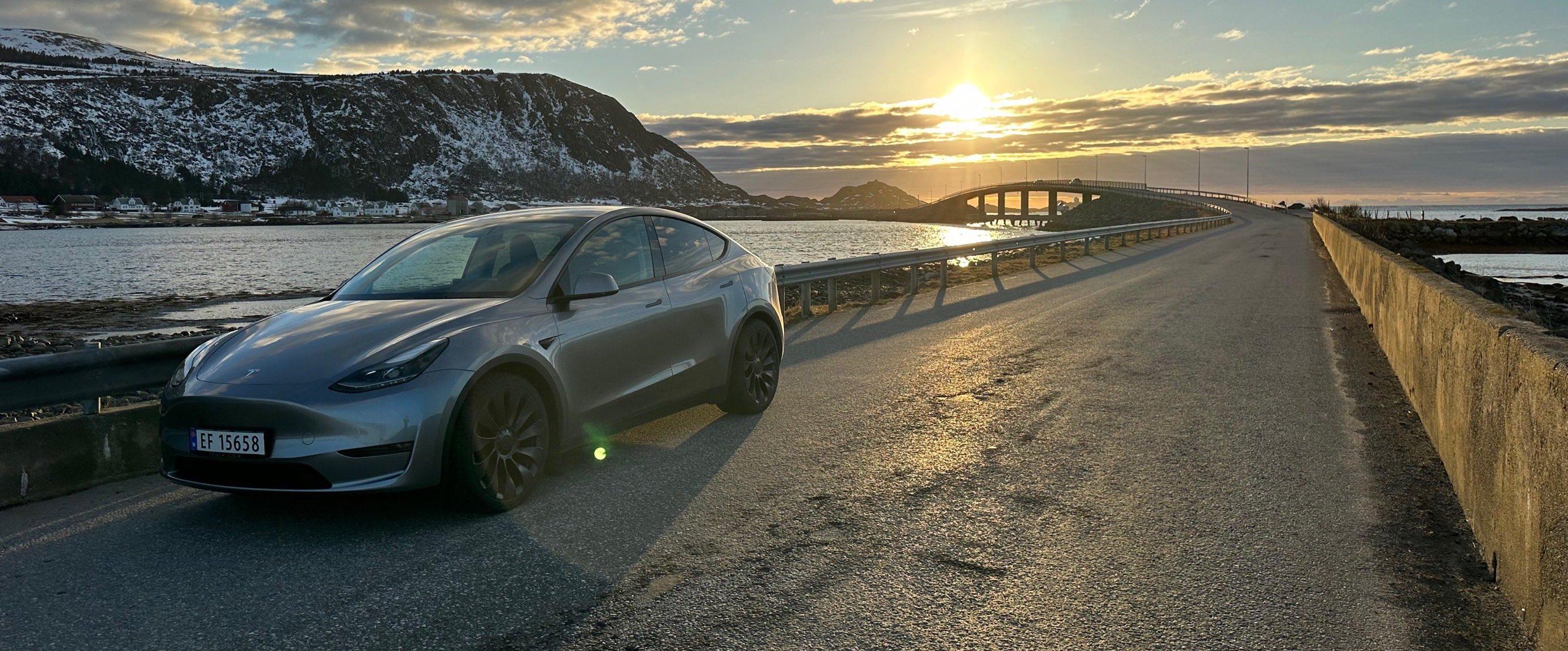 A Tesla driving on a bridge