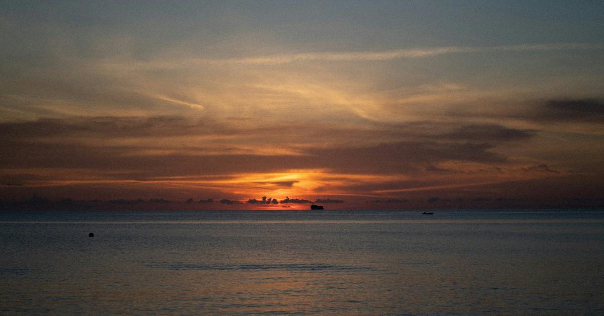 The sun sets over the waters of the Cayman Islands