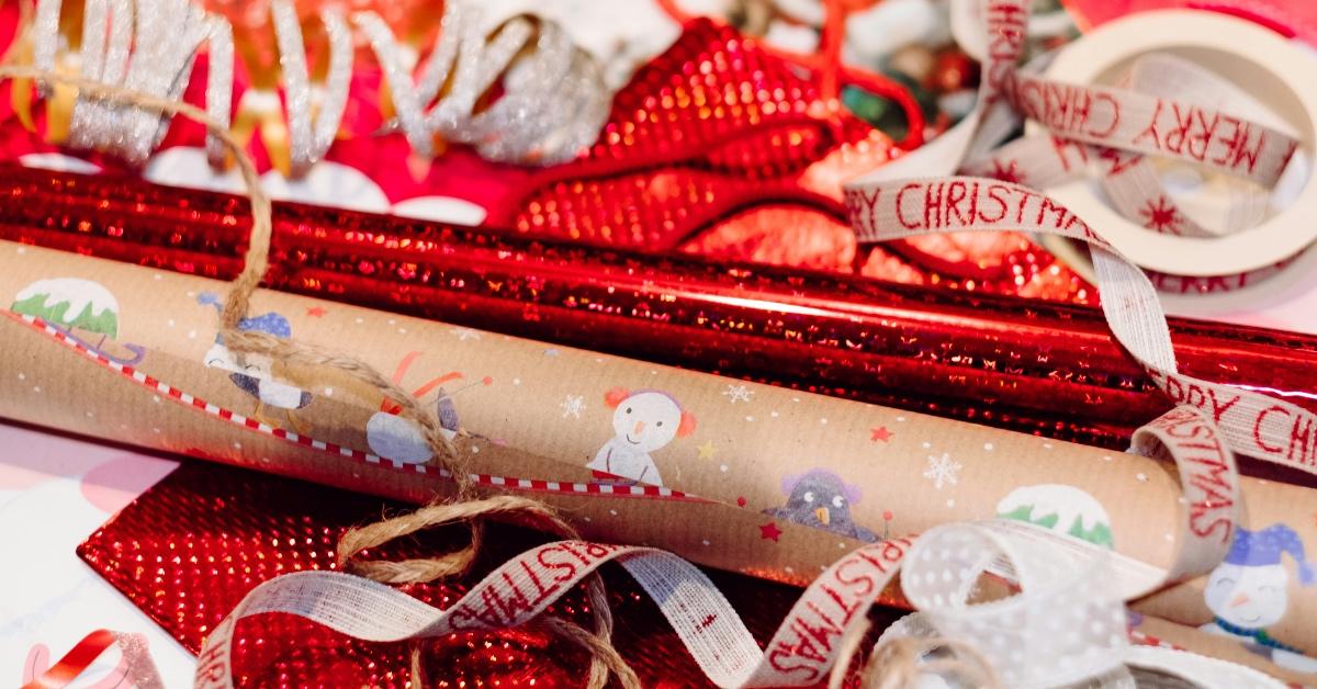 Pile of Christmas wrapping paper in red, brown and white shades. 