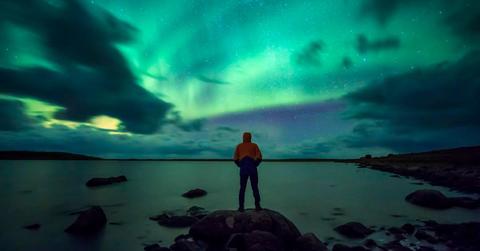 A man admiring the Northern Lights aurora in the Arctic. (Representative Cover Image Source: Getty Images | Westend61)