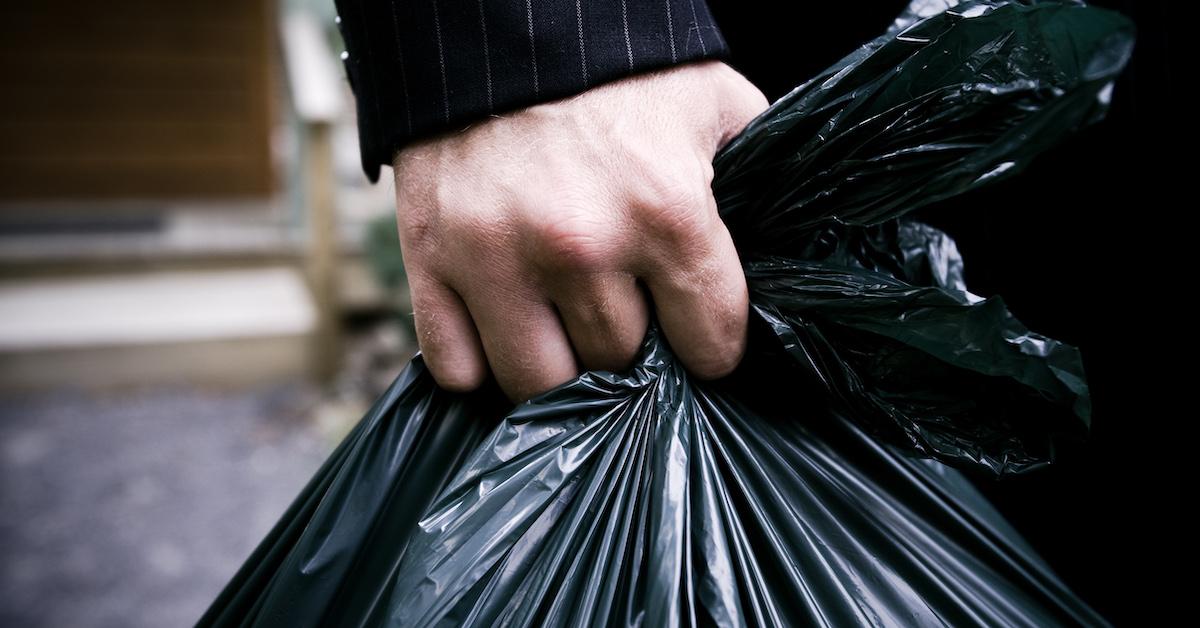 Closeup of hand holding black trash bag