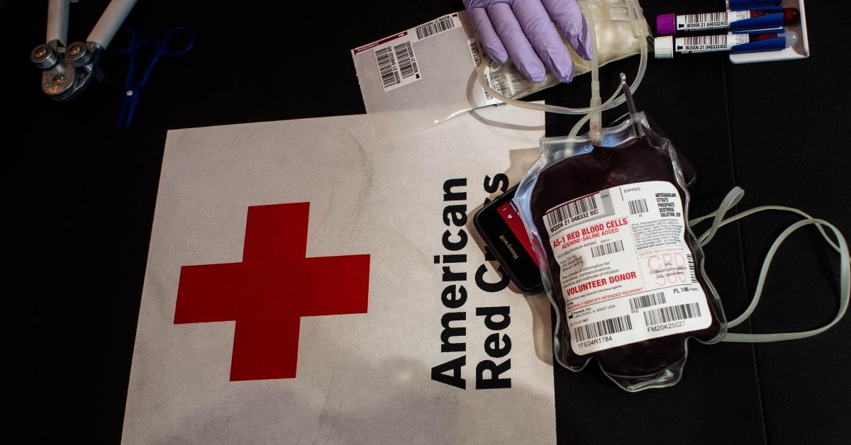 American Red Cross sign and a bag of donated blood. 