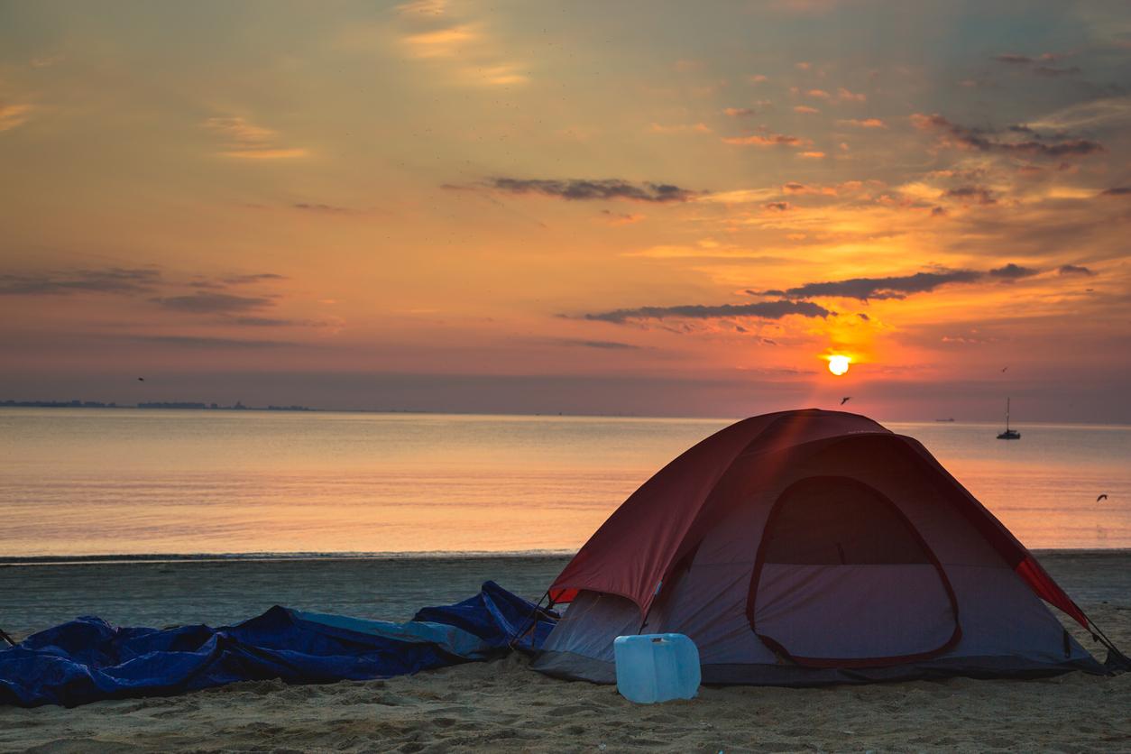 Tent set up on beach during the sunset