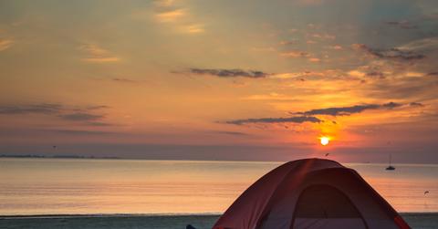 Tent set up on beach during the sunset