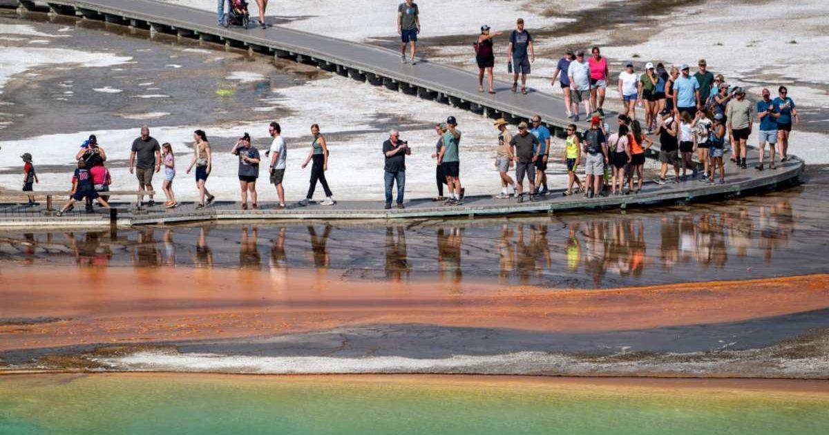 Visitors near Grand Prismatic Spring, Yellowstone's largest hot spring. (Representative Cover Image Source: Getty Images | Jonathan Newton)