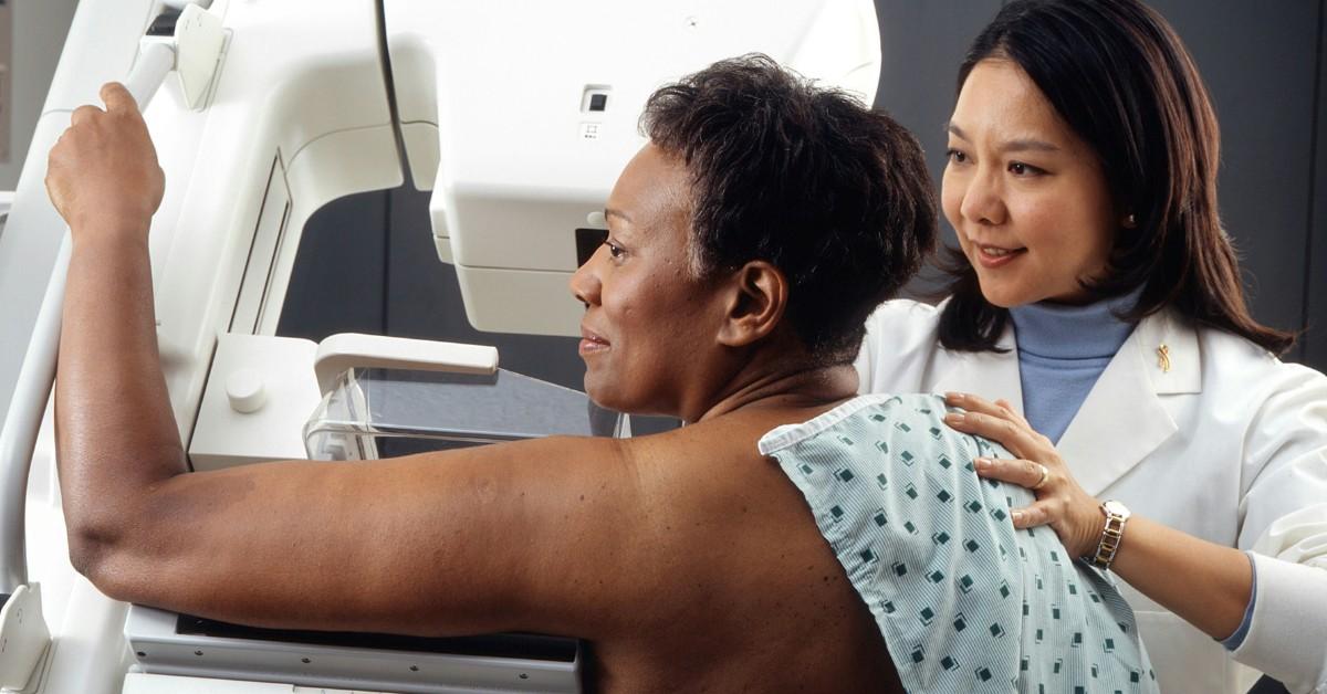 A side view of a woman having a mammogram performed 