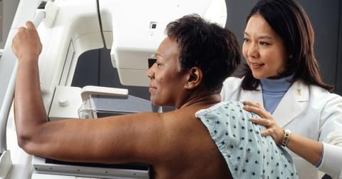 A side view of a woman having a mammogram performed