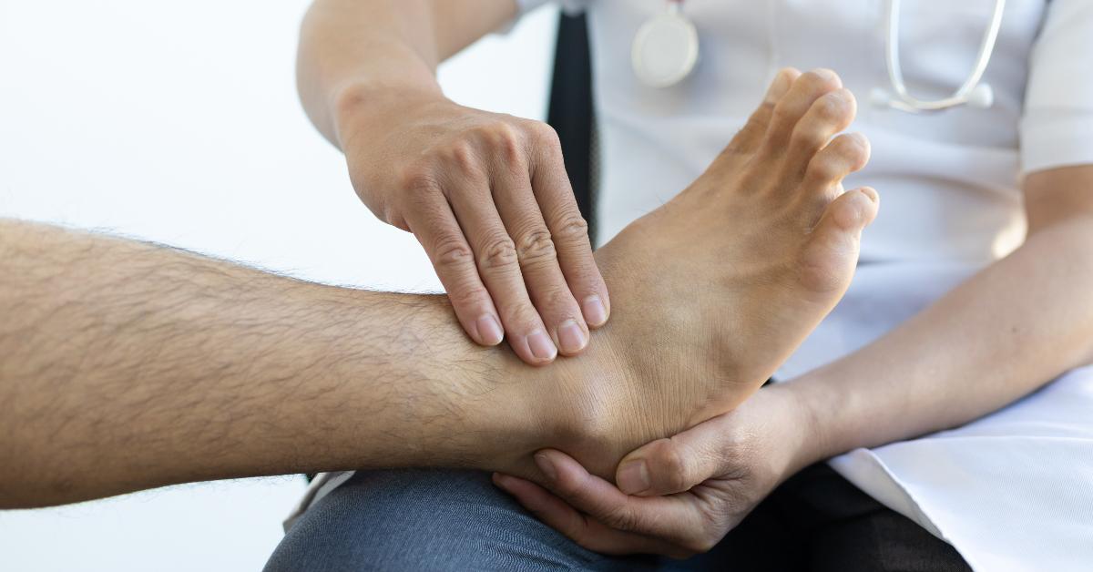  Photo of a podiatrist checking a patients foot and ankle