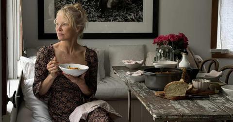 Pamela Anderson is relishing a meal while looking out the window. (Cover Image Source: Instagram | @pamelaanderson)