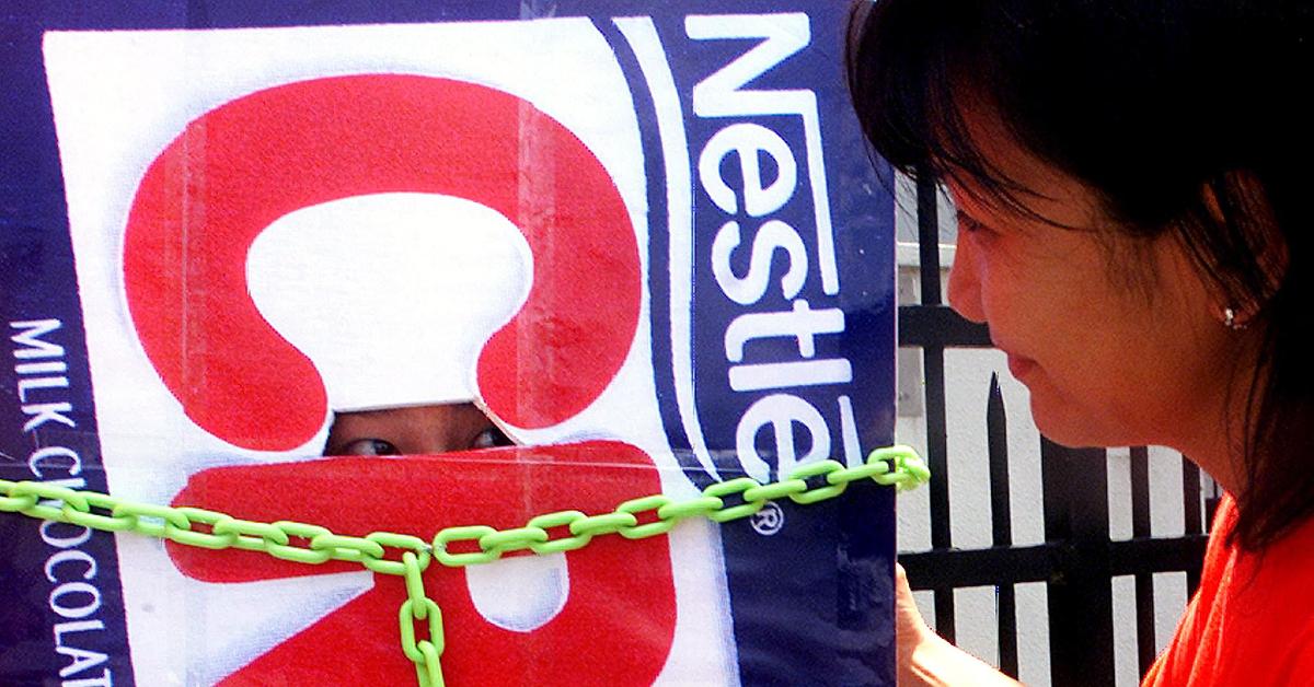 Greenpeace protester dressed in a chained Nestlé Crunch bar costume 