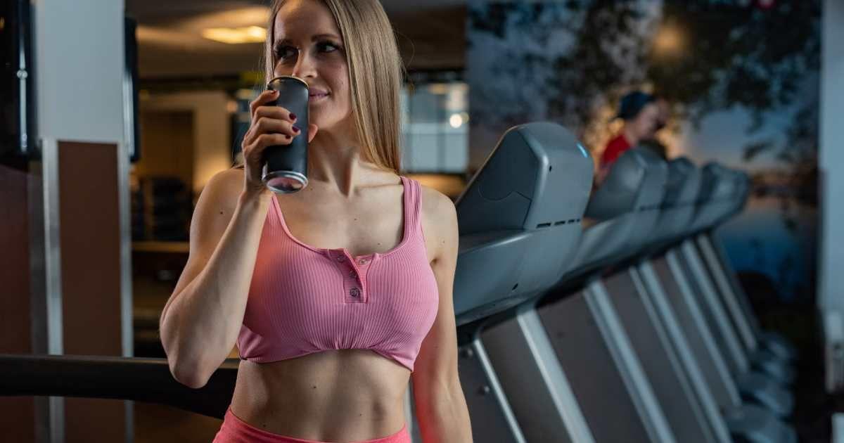 A woman in a fitness studio drinking a can of an energy drink (Representative Cover Image Source: Getty Images | Isbjorn)