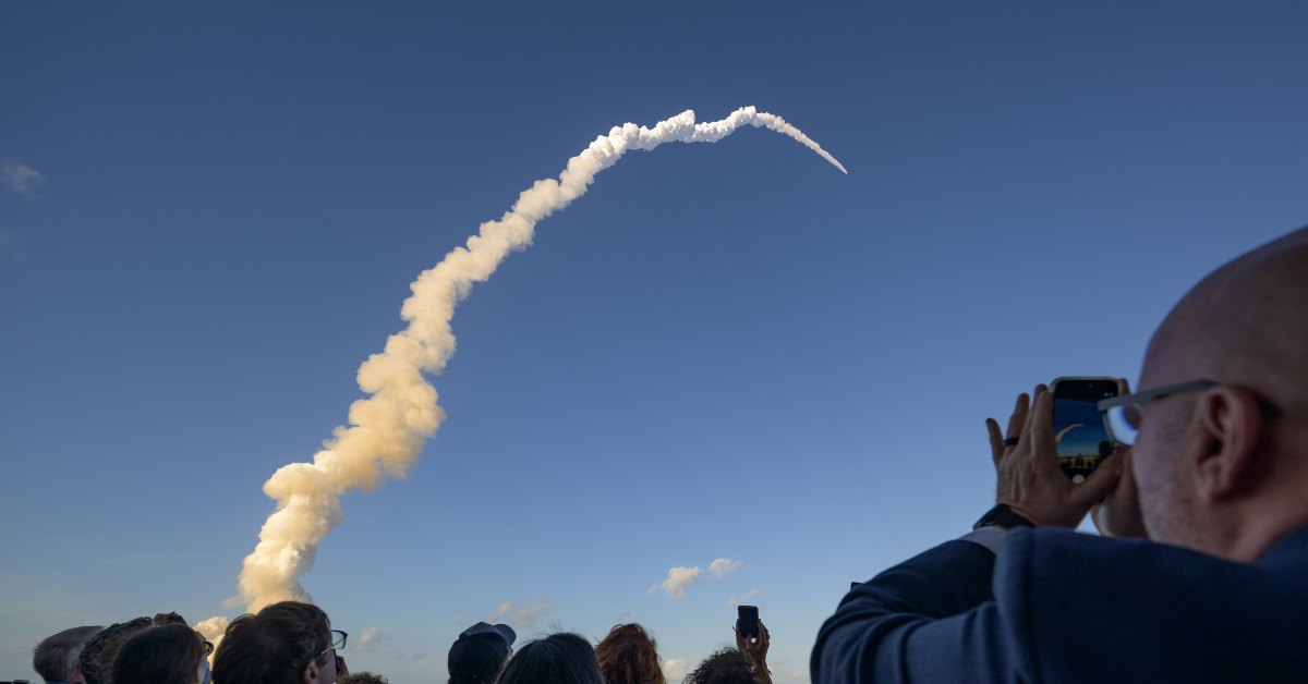 People on the ground watch the path of Artemis II as it heads away from Earth and towards the moon