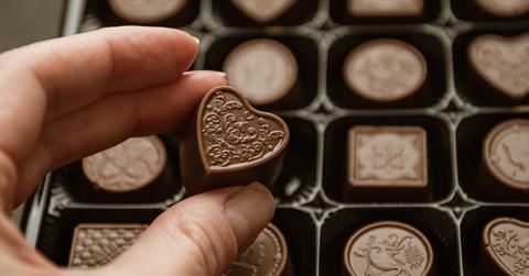 Person holding box of chocolates