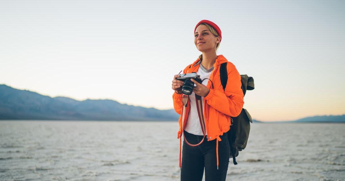 A woman taking photographs in Death Valley. (Representative Cover Image Source: Getty Images | Fokkebok)