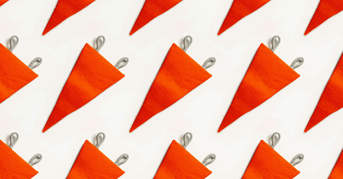 A series of red flags lay against a white backdrop 