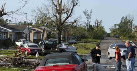 Local residents are pictured standing in the street in May 2011 following the destructive tornado in Joplin, Missouri.