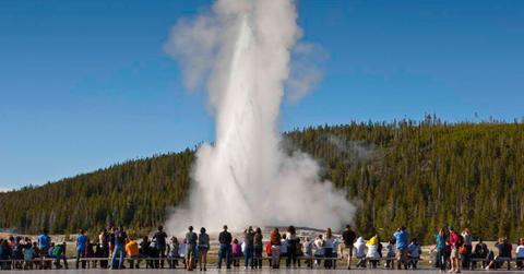 Tourists gather to watch a geyser eruption at Yellowstone National Park. (Representative Cover Image Source: Getty Images | Danny Lehman)