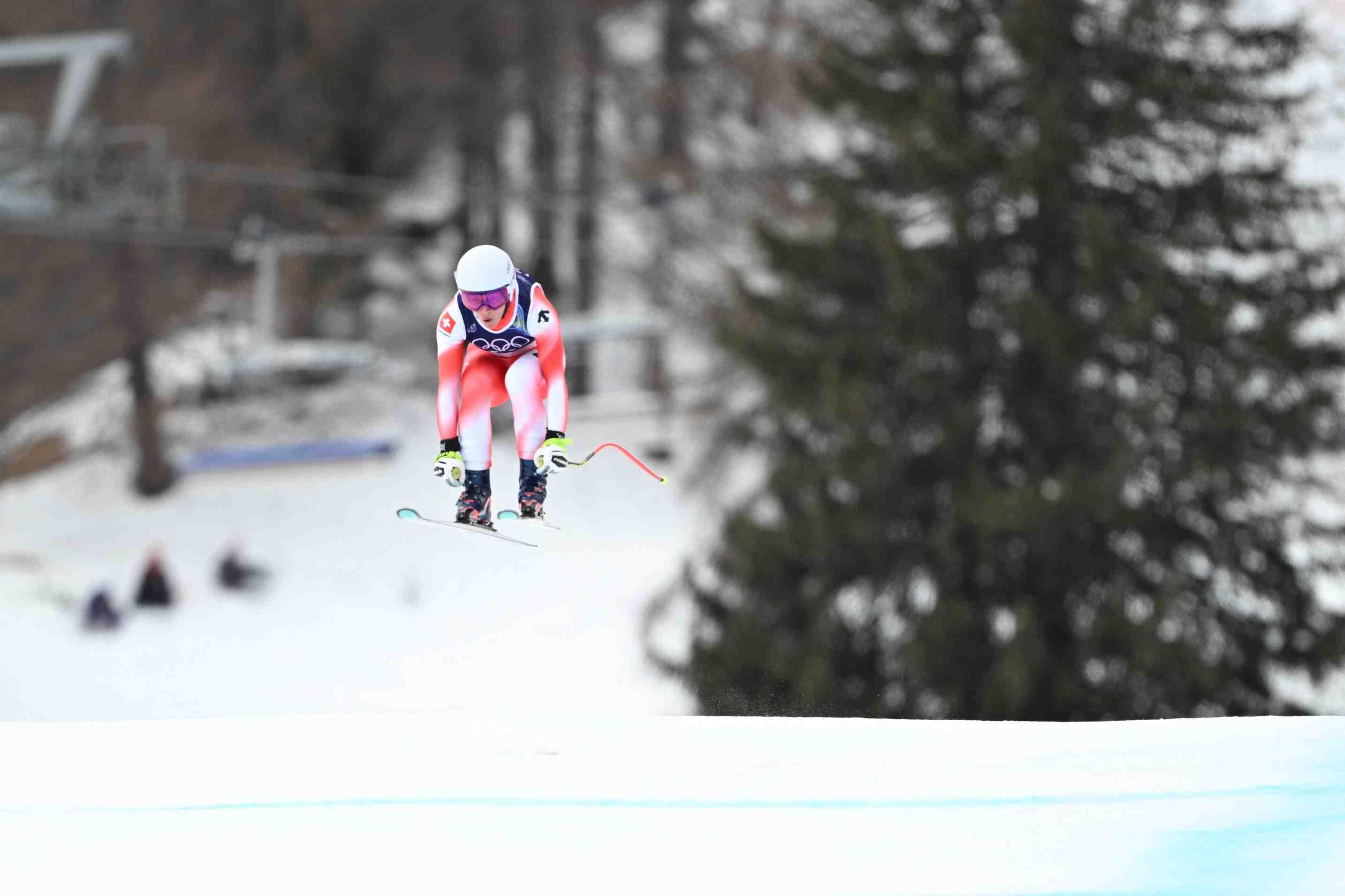 A Swiss Olympic skier is pictured midair on the Tofane Alpine Skiing Centre course in Cortina, Italy on Feb. 10 at the 2026 Winter Olympic Games.