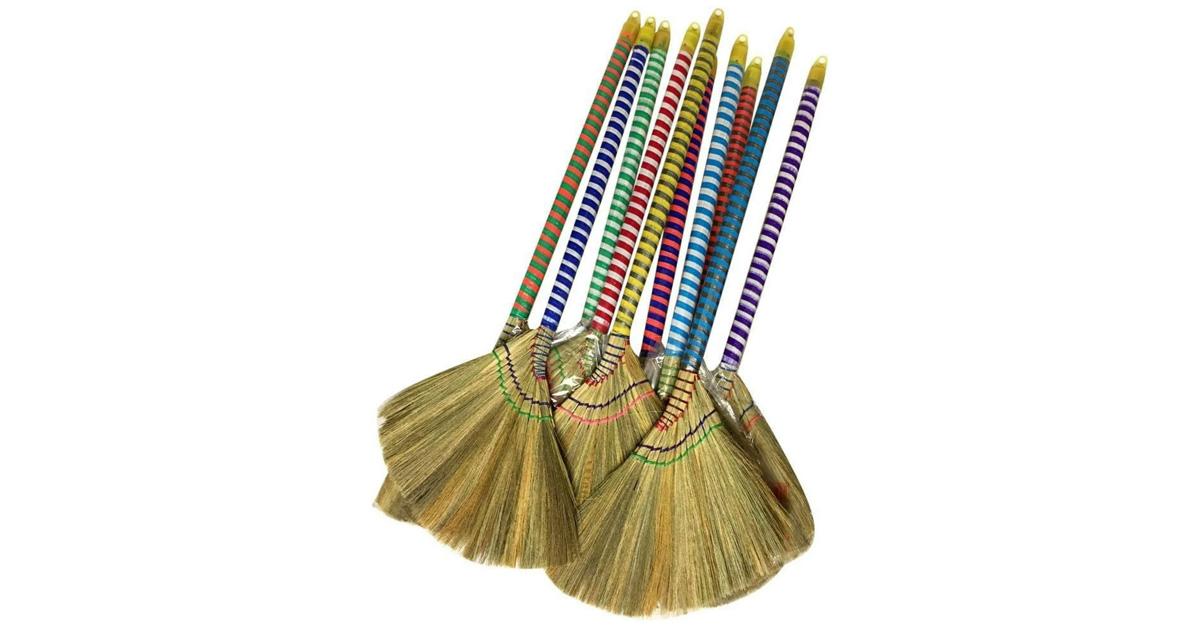 a bunch of Vietnamese straw brooms with colorful striped handles