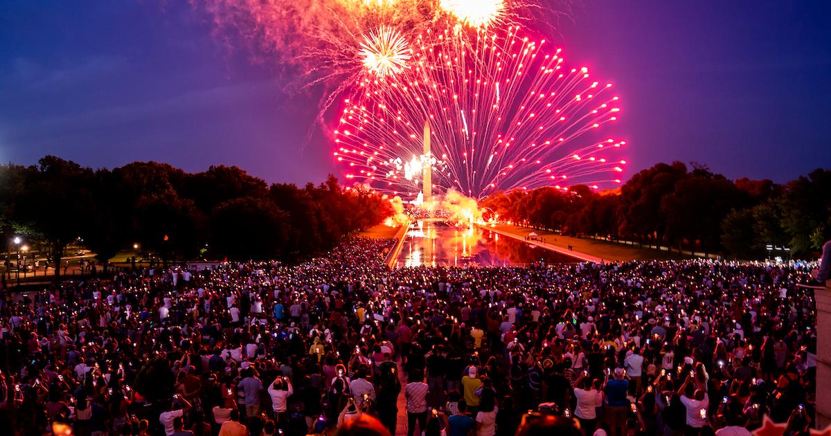 Fireworks explode over a crowd