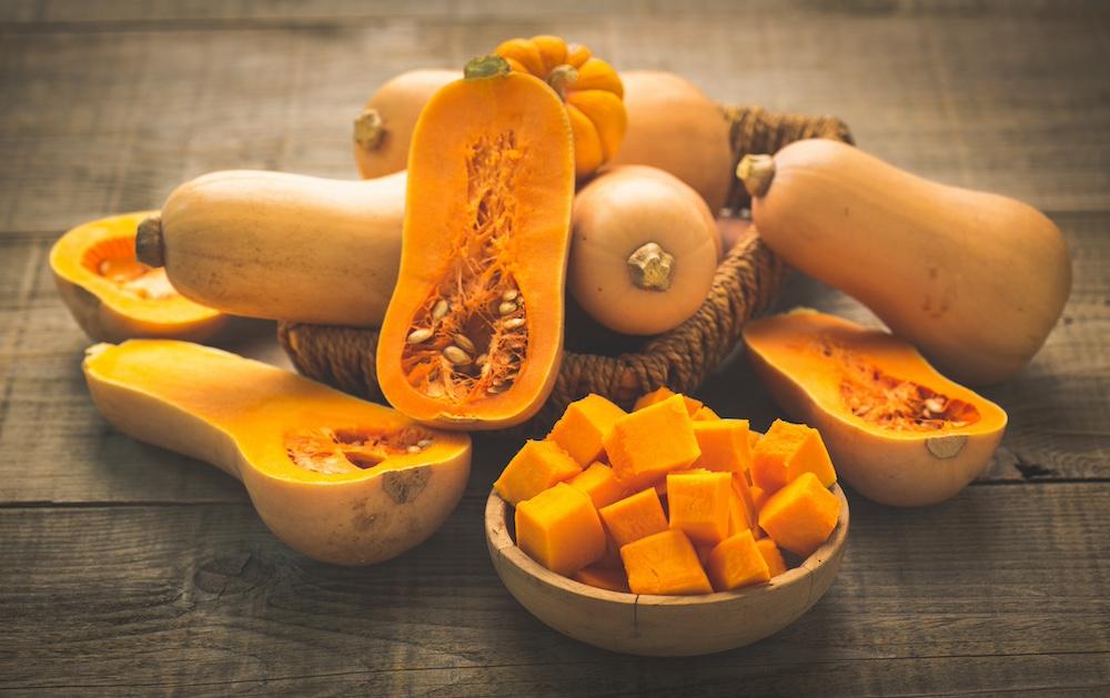 Fresh butternut squash on a wooden table. 