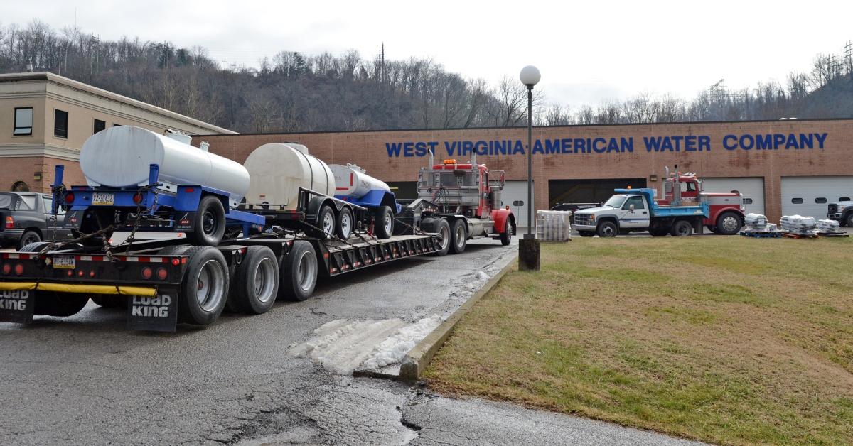 A tow truck sits in front of a building with a sign reading "West Virginia American Water Company."