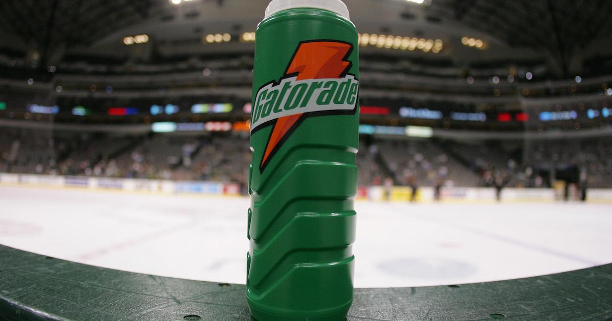 A Gatorade water bottle sits on the boards at the bench during an NHL game 