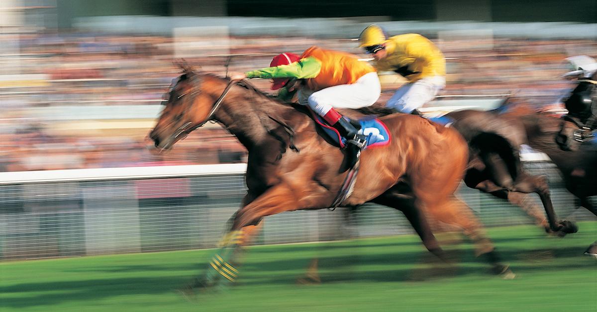 An action shot of a jockey riding a horse.