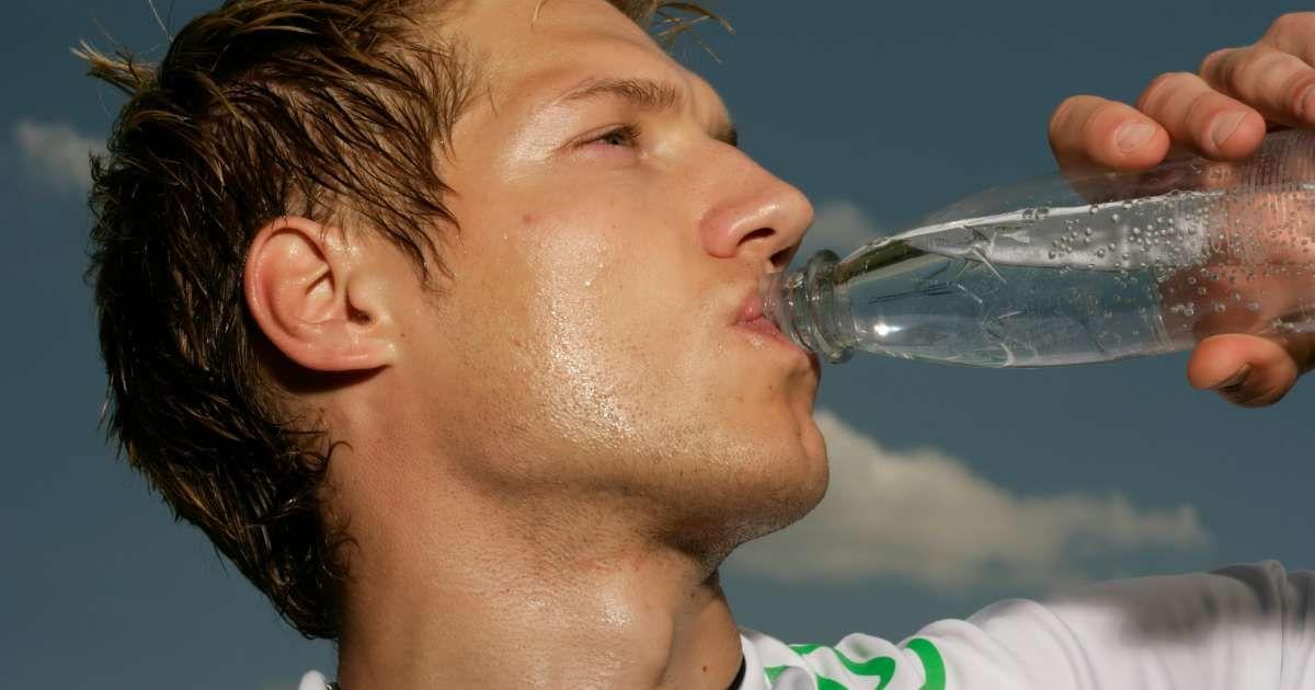 An exhausted man drinks sparkling water from a bottle during summer (Representative Cover Image Source: Pexels | Boom)