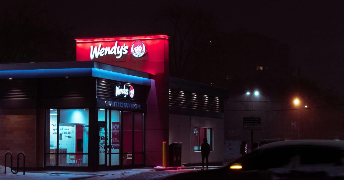 A Wendy's sign is illuminated in the night