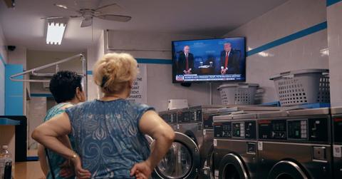 Women stand inside a laundromat. (Representative Cover Image Source: Getty Images | Andres Kudacki)