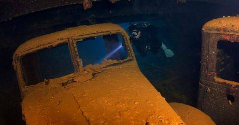 A diver captured exploring a car underwater. (Representative Cover Image Source: Getty Images | apsimo1)