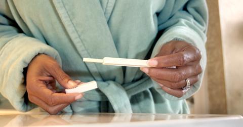 Woman holding a pregnancy test