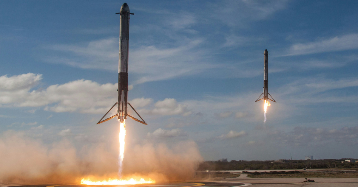 The SpaceX Falcon sits in a circle of fire as it makes a heavy landing